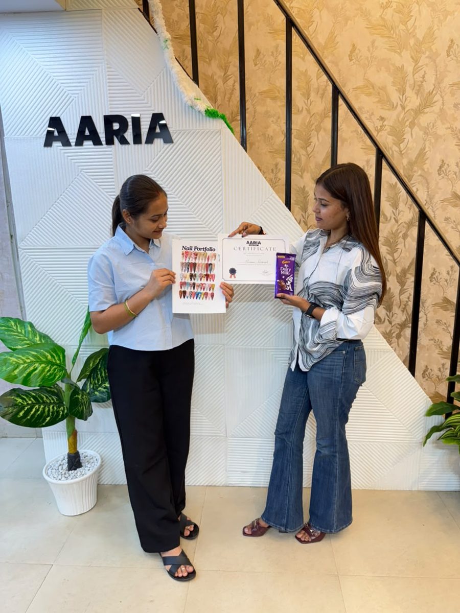 Student receiving her AARIA nail course certificate